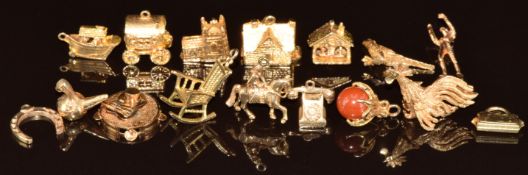 Seven 9ct gold charms including chair, telephone, horseshoe, purse, talon holding a bead, lady