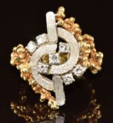 An 18k bi-coloured gold 1970's ring set with seven diamonds of approximately 0.05ct each, 10.5g,