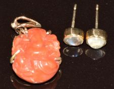 A 9ct gold pendant set with carved coral depicting Ganesh and a pair of 9ct gold earrings set with a