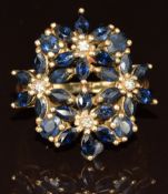 A 9ct gold ring set with marquise and oval cut sapphires and diamonds in flower clusters, 5.6g, size