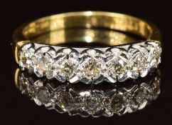 An 18ct gold ring set with seven round cut diamonds, 4.4g, size R