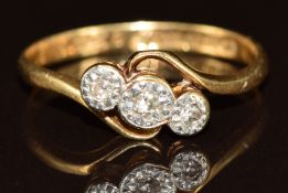 An 18ct gold ring set with three diamonds in a platinum setting, 2.2g, size O