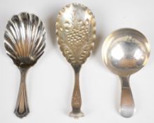 Three 19th century hallmarked silver caddy spoons including a plain Georgian example and a