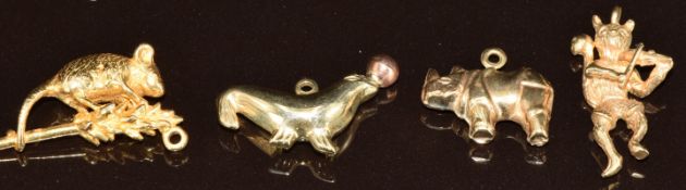 Four 9ct gold charms including seal, rhino, mouse on a piece of wheat and a cat playing the