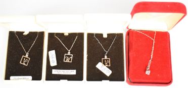 Twenty silver chains and nineteen silver pendants including initials, shamrocks, cross, etc