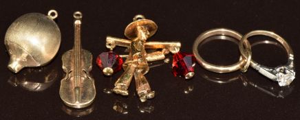 Four 9ct gold charms/ pendants in the form of a hedgehog, violin, engagement ring and wedding band