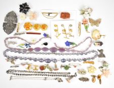 A collection of costume jewellery including vintage brooches, tie pins, 9ct gold cricket player