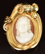An 18ct gold brooch with scrolling decoration set with a cameo of a young woman, 24.4g, 3.5 x 4.6cm
