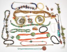 A collection of jewellery including sandalwood necklace with coral, amber, shell and glass beads,