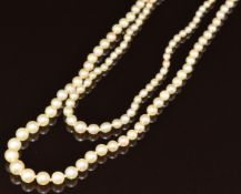 A double strand pearl necklace comprising one strand of 137 cultured pearls and one strand of 127