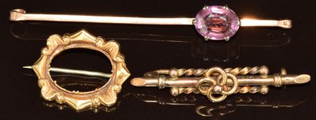 A 9ct gold brooch set with an oval amethyst, a c1900 9ct gold brooch (6.5g) and a Victorian brooch