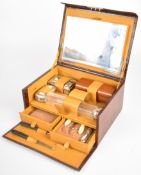 Vintage travelling vanity case with bevelled glass mirror, silver plate topped bottles, manicure set