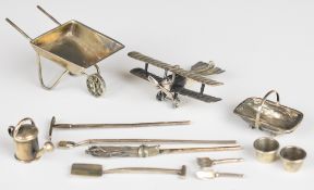 Novelty hallmarked silver items comprising WW1 or similar biplane, and a gardening set made up of