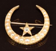 Edwardian 18ct gold brooch in the form of a crescent and star set with an old cut diamond and