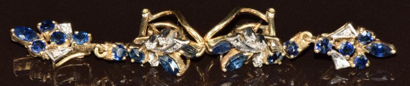 A pair of 14ct gold earrings each set with three marquise cut and six round cut sapphires and