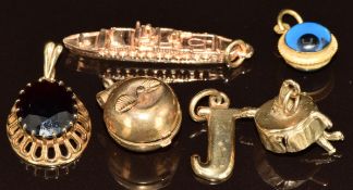 Five 9ct gold charms/ pendants including garnet set, Oriana ship, 'J', apple opening to reveal