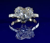 An 18ct gold ring set with a heart cut diamond of approximately 3.62ct and with further Asscher