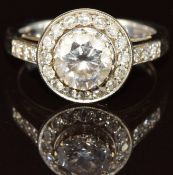 An 18ct gold ring set with a 1.4ct round brilliant cut diamond surrounded by 16 round cut diamonds