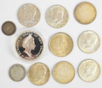 New Zealand fan tail one Dollar silver coin, five United States of America Kennedy half Dollars, two