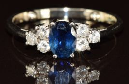 An 18k white gold ring set with an oval cut sapphire of approximately 0.65ct and six diamonds, 3.1g,