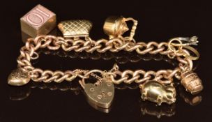 A 9ct gold charm bracelet with seven 9ct gold charms including pig, heart, purse, 10 shilling