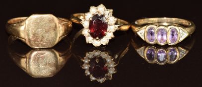 Three 9ct gold rings, one set with amethysts, one garnet surrounded by pearls and the other a signet
