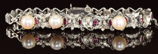An 18k white gold bracelet set with marquise cut rubies, diamonds and cultured pearls (two pearls