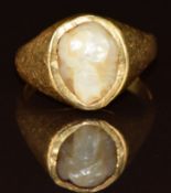 A yellow metal ring set with a pearl, tests as 18k gold, 5.5g, size J