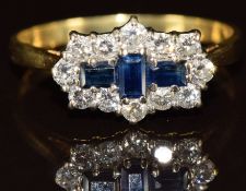 An 18ct gold ring set with three baguette cut sapphires surrounded by diamonds, 3.5g, size S