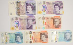 Bank of England Elizabeth II and Charles III polymer banknotes comprising two £20 (one with AA33