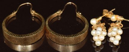 A pair of 9ct gold hoop earrings with ridged decoration and a pair of 9ct gold earrings set with