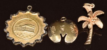 Three 9ct gold pendants/ charms including palm tree, coco de mer and Parthenon, 5g