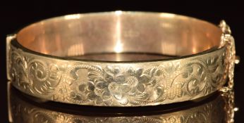 A 9ct gold wax filled bangle with engraved decoration, 23g,