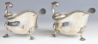Pair of George V hallmarked silver sauce boats with gadrooned edges, scroll handles with acanthus