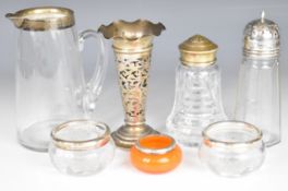 Hallmarked silver mounted items comprising lemonade jug, two sugar casters, trumpet vase, pair of