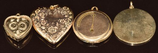 A yellow metal pendant and three lockets