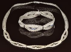 An 18k white gold necklace made up of twisted curb links plaited set with sapphires with matching
