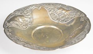 Indian or Burmese silver dish with embossed decoration of animals, marked to underside 840, diameter