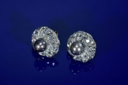 A pair of platinum and 18ct white gold earrings each set with a natural brown/ black pearl measuring