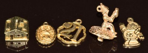 Four 9ct gold charms comprising St Christopher, 21st, pixie on a toadstool and 'Expo' charm (6g) and