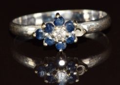 A 9ct white gold ring set with a diamond and sapphires (one sapphire missing), 1.6g, size O