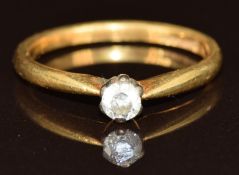 An 18ct gold ring set with a round cut diamond of approximately 0.15ct, size M, 2.5g