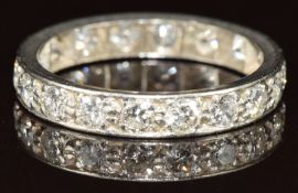 A platinum eternity ring set with eighteen round cut diamonds, each approximately 0.07ct, 3.3g, size