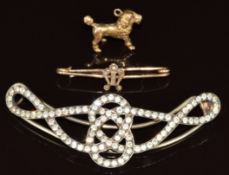 A silver gilt hair clip set with paste, 9ct gold charm in the form of a poodle and a 9ct gold brooch