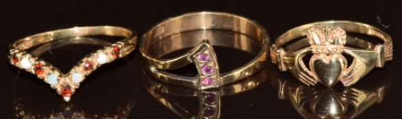 Three 9ct gold rings, one set with garnets and opals, one rubies and the other Claddagh, 4.4g,