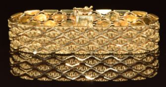 An 18k gold bracelet made up of textured diamond shaped links, 44.2g, 19cm