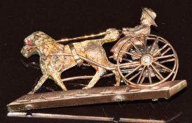 A c1900 yellow metal brooch in the form of a poodle pulling a trap/carriage set with a diamond,
