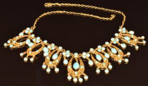 An 18k gold necklace set with turquoise cabochons and with filigree decoration, believed to have
