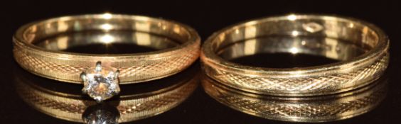 A 14k gold ring set with a diamond of approximately 0.1ct, with matching band, 3.9g, size M
