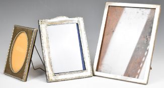 Three hallmarked silver photograph frames comprising plain example to suit 8 x 4 inch photo,